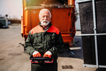 Wall Mural - Portrait of a mature worker of the city utility company. Garbage collector.