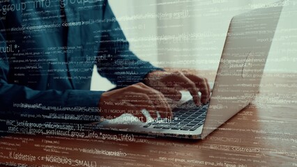Computer programmer uses capable laptop computer to develop programming code of new software . Computer specialist working on future coding application for software programming development .