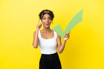 Sticker - Young african american woman isolated on yellow background holding a check icon and pointing up