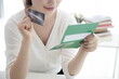 © 상은 신 - Young woman holding credit card with bank book