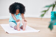© Micah C/peopleimages.com - Treat your body well and it will reward you. Shot of a young girl practicing yoga at home.