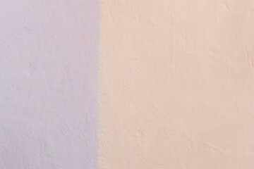 Wall Mural - The colored wall is two colors: light warm cream or peach and lilac bright abstract paint background design