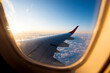 Leinwandbild Motiv Looking at the sunset through the airplane window