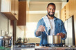 © Nicholas Felix/peopleimages.com - I cant wait until its done. Shot of a young man cooking at home.