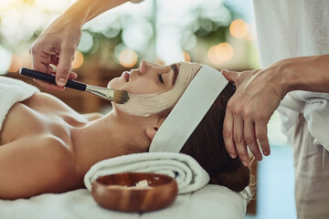 Poster - Indulging in a deep cleansing masque. Shot of an attractive young woman getting a facial at a beauty spa.