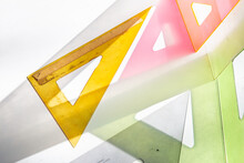 Colored Drafting Triangles On White With Shadows