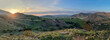 Panorama of hills, mountains, green valleys with citrus orchards and farming fields  as the sunsets in southern California countryside