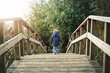 © Jadon Bester/peopleimages.com - Wondering off into the world. Rear view shot of a little boy crossing a bridge at a park.