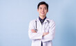 © Timeimage - Portrait of young Asian male doctor on blue background