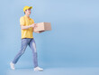 © Timeimage - Full length image of Asian delivery man on blue background