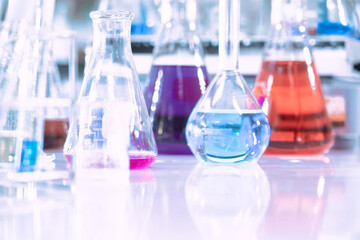 Wall Mural - glass flask in chemical science education laboratory with molecular structure in blue background