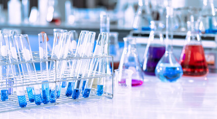 Wall Mural - glass flask in chemical science education laboratory with molecular structure in blue background