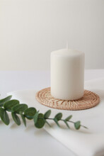 White Candle With Green Eucalyptus On White Background, Modern And Cozy  Home