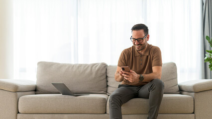 Adult man typing message on his phone