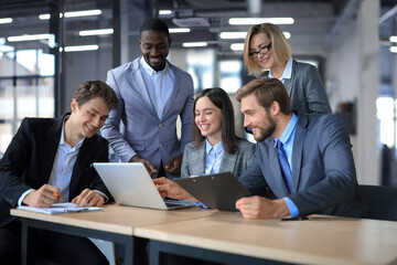 Poster - Group of happy young business people in a meeting at office.