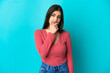 © luismolinero - Young caucasian woman isolated on blue background having doubts
