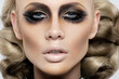 Closeup front portrait of blonde woman with artistic hairstyle and makeup, dramatic look, smokey makeup.