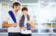 © STEEX/peopleimages.com - Fitness man and woman at fitness center. Portrait of fitness couple with arms around at gym.