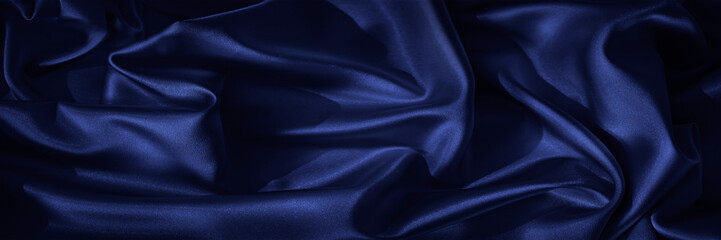 Wall Mural - Black blue silk, satin. Shiny fabric surface. Beautiful wavy folds. Dark elegant background with space for design. Web banner.