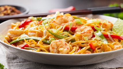 Wall Mural - Stir fry noodles with prawns and vegetables in white plate. Healthy asian food