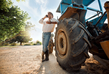 Ill be able to sell these and many more. Shot of a young man talking on a cellphone while working on a farm.