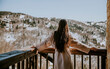 © BGStock72 - Charming young woman in bathrobe enjoying the winter nature on the large terrace