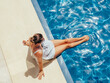 Fashionable woman sitting by the pool on the empty deck of a cruise liner. Closeup, outdoor. Vacation and travel concept