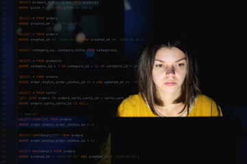 Girl works on a laptop at night, coding and creating project.