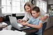 © Chanelle M/peopleimages.com - I think we need to change the password. Shot of a mother and son team using a laptop to complete home schooling work.