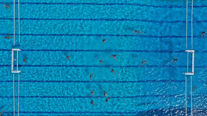 Aerial drone top down photo of water polo tournament as seen in huge pool