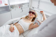 © Friends Stock - Joyful woman receiving laser epilation treatment in beauty salon