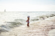 Child kid standing hesitated on beach in front of sea and going to swim concept children overcoming fear of water 