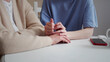 © iaginzburg - Daughter visiting elderly mother. They sit at the table and talk about serious things