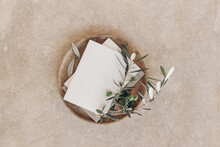 Summer Wedding Stationery Mock-ups. Blank Greeting Cards, Craft Envelope With Olive Fruit, Branch. Wooden Plate, Tray. Beige Marble Stone, Textured Background. Flat Lay, Top View. Mediterranean Design