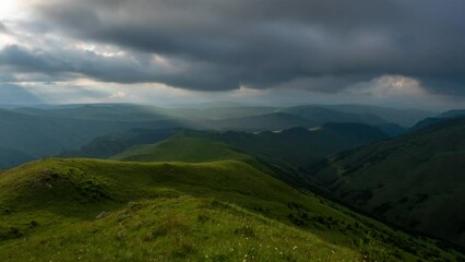 Wall Mural - Beautiful mountain landscape with sun rays on hills and clouds, timelapse 4k