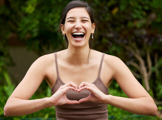 Sticker - Yoga is about gaining closeness to good vibes. Portrait of a young woman making a heart shape with her hands while exercising outdoors.