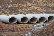Reinforced Concrete Storm Sewer Pipes Stacked At A Construction Site Large Diameter Pipes