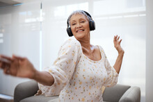 Every Time You Dance, You Defy Your Age A Little More. Shot Of A Senior Woman Dancing While Using Headphones At Home.