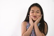 © dul_ny - Isolated portrait of Asian little girl on white background, positive feeling little girl, funny pose by balancing a pencil between her mouth and nose, black long hair. Concept for children education.