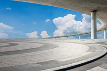 Empty Square Floor And Bridge With Sky Clouds Under Blue Sky