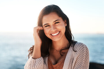 Be confident and watch your happiness grow. Portrait of a happy young woman enjoying a day at the beach.