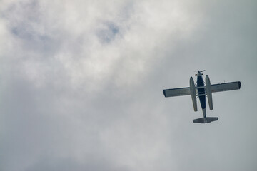 Canvas Print - Skyward view of a small airplane in the sky.