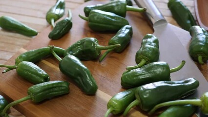 Wall Mural - Vegetable ingredients for cooking, organic green Padron peppers on table