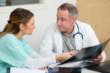 portrait of doctors studying x-ray film