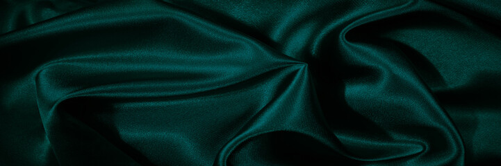 Wall Mural - Dark green silk satin. Shiny silky surface of the fabric. Wavy folds. Elegant background with space for design. Web banner. Valentine, Christmas, holiday background.