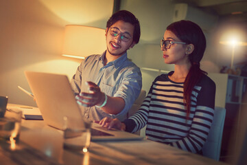 Poster - Well beat this deadline in no time. Shot of two young designers working late on a laptop in an office.