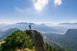 © Westend61 - Man standing on top of mountain on sunny day