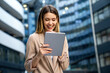 Portrait of successful woman using digital tablet in urban background. Business people concept