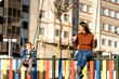 © Westend61 - Happy young woman and son on swing in park