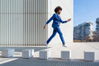 © Westend61 - Playful businessman jumping on concrete block
